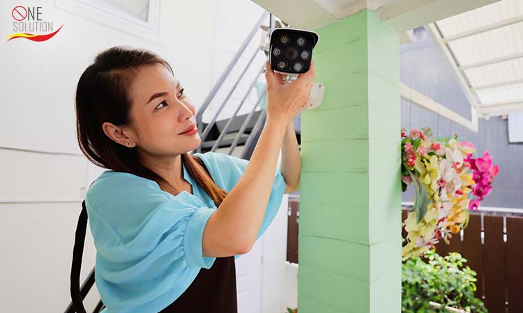 a person adjusting CCTV home surveillance camera